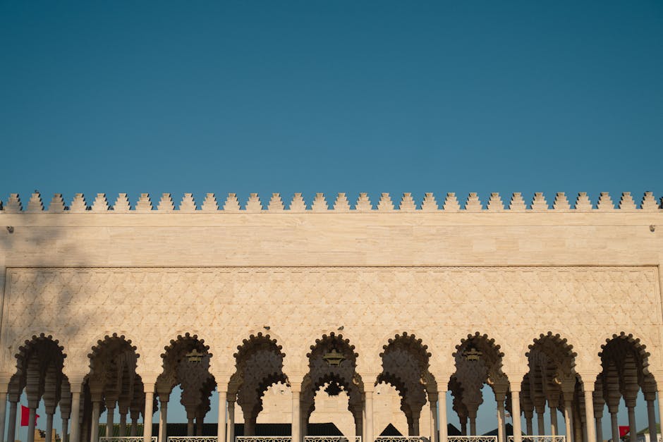 Beautiful Moorish architectural facade with intricate arches under a clear blue sky